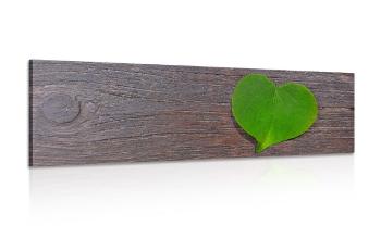 Obraz liść w kształcie serca na drewnianym tle